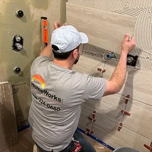 HomeWorks cgo employee installing tile