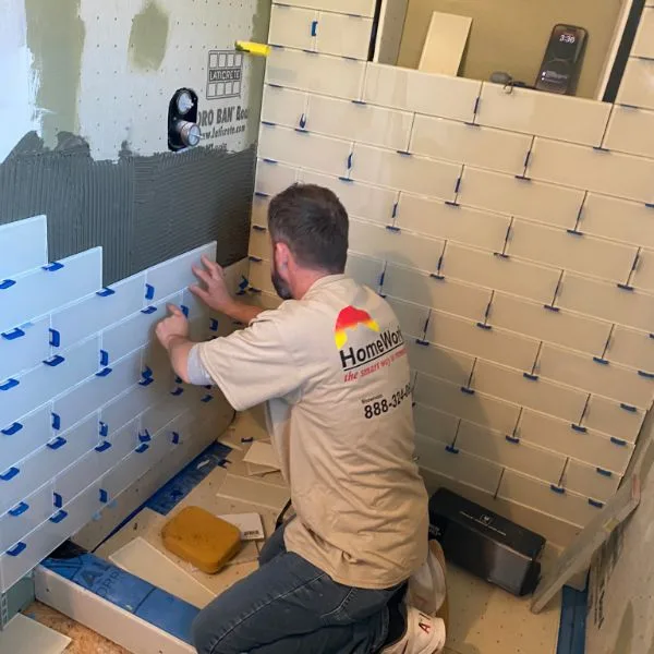 HomeWorks cgo employee setting tile in shower