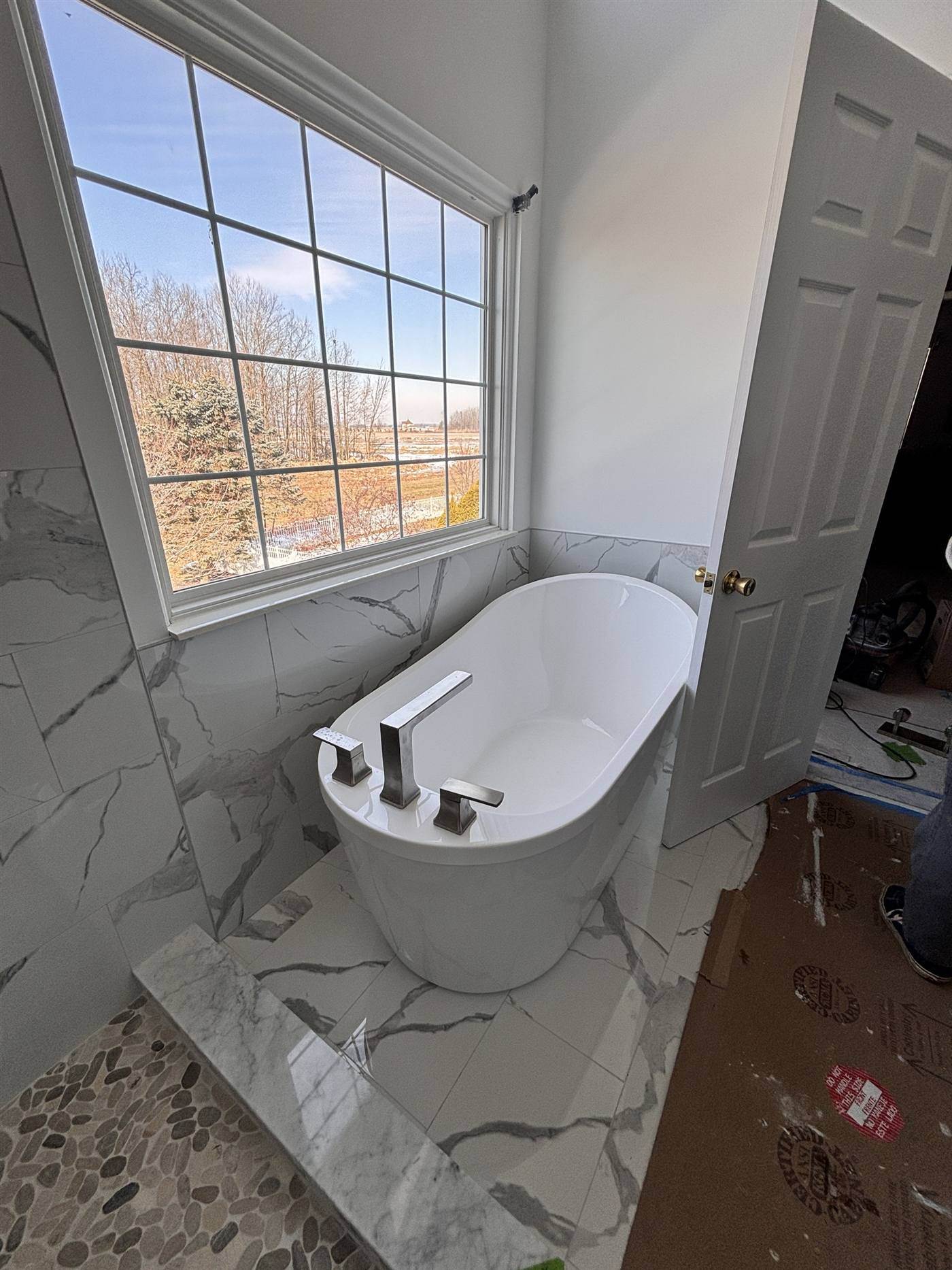 Freestanding tub beside a tiled shower