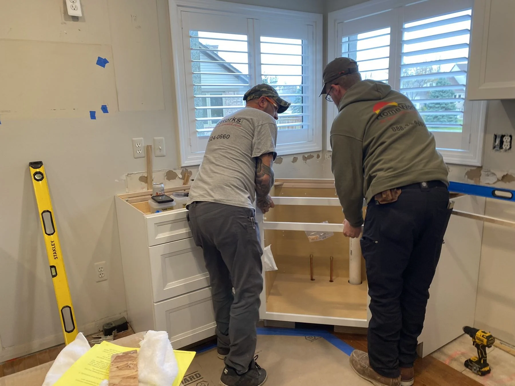 HomeWorks crew installing kitchen cabinets