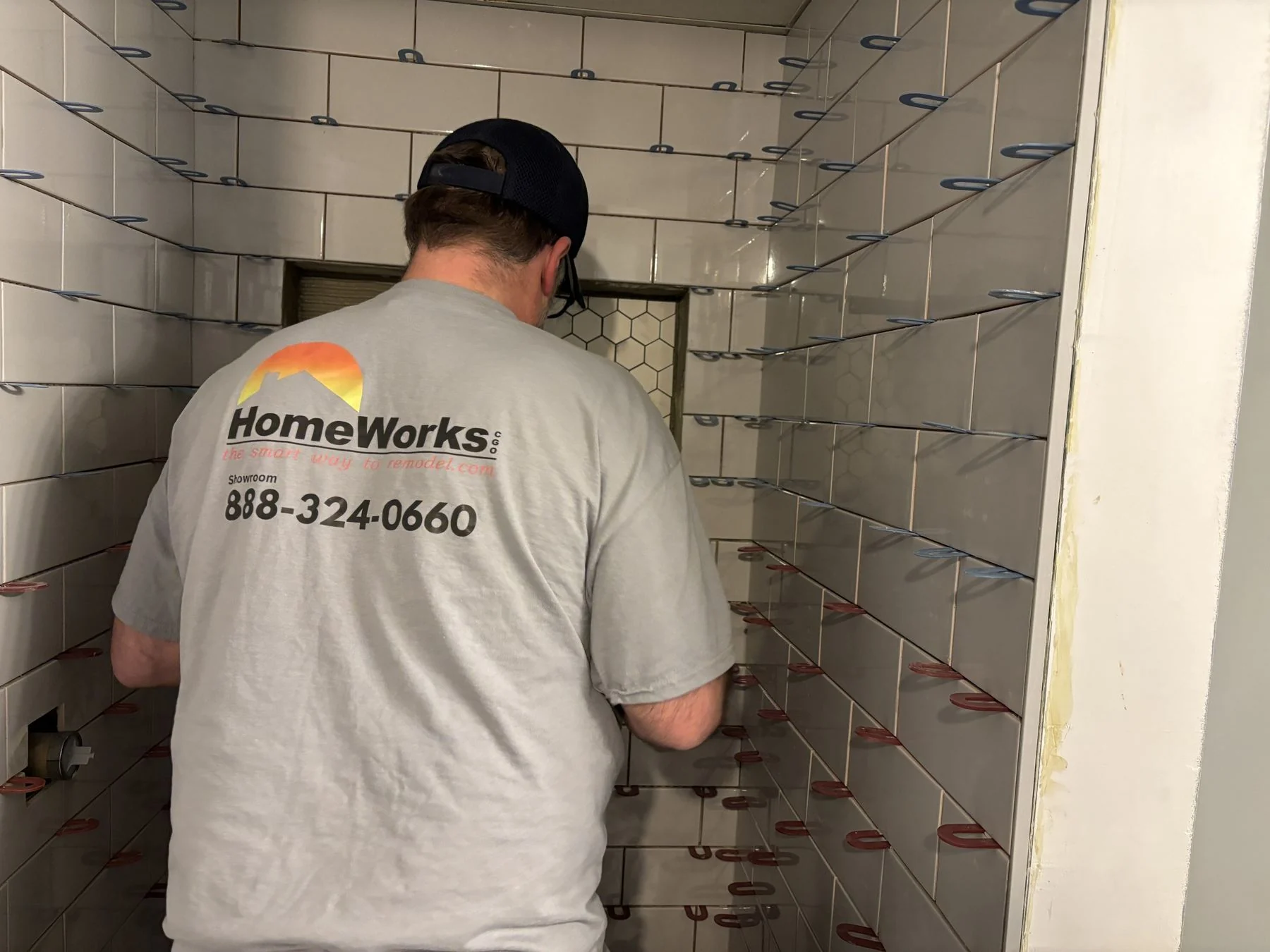 HomeWorks installer setting shower tile