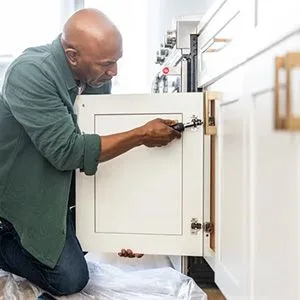 man refacing kitchen cabinets