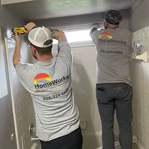 HomeWorks cgo inc employee removing shower tile