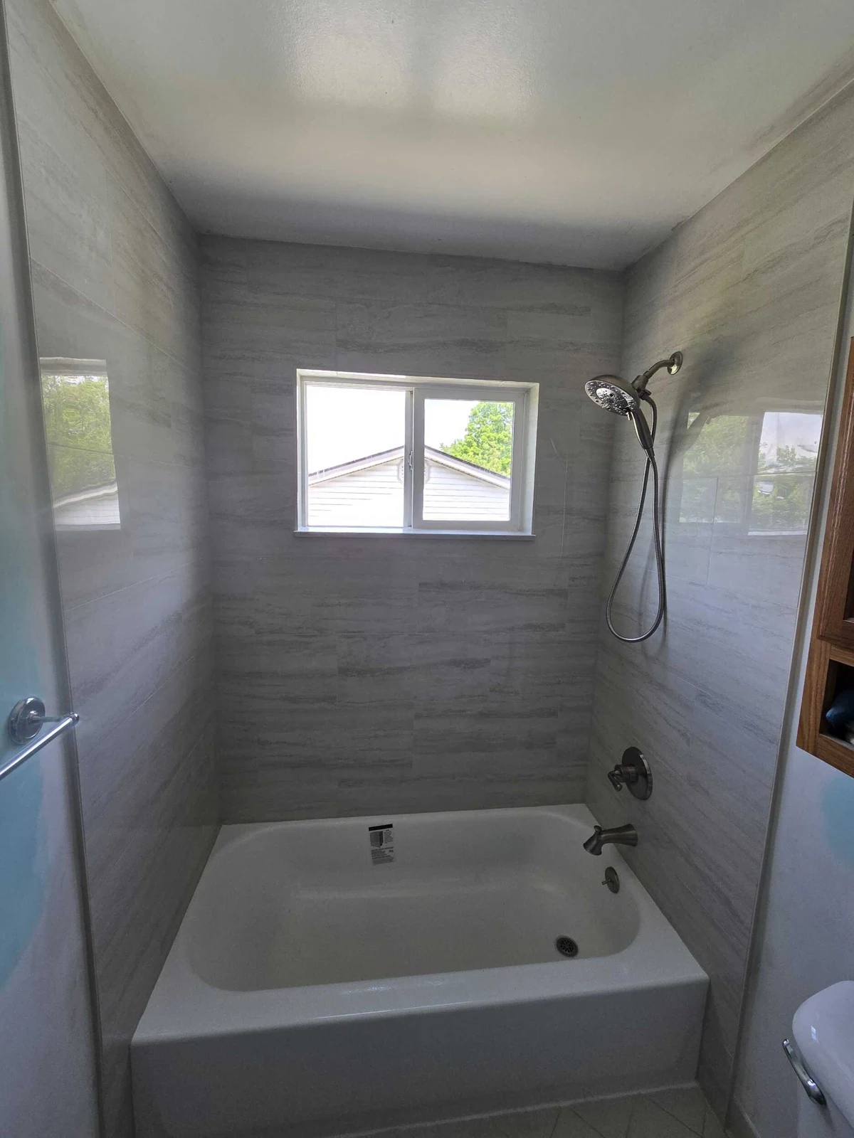 Picture of shower wall with window in shower and water damage