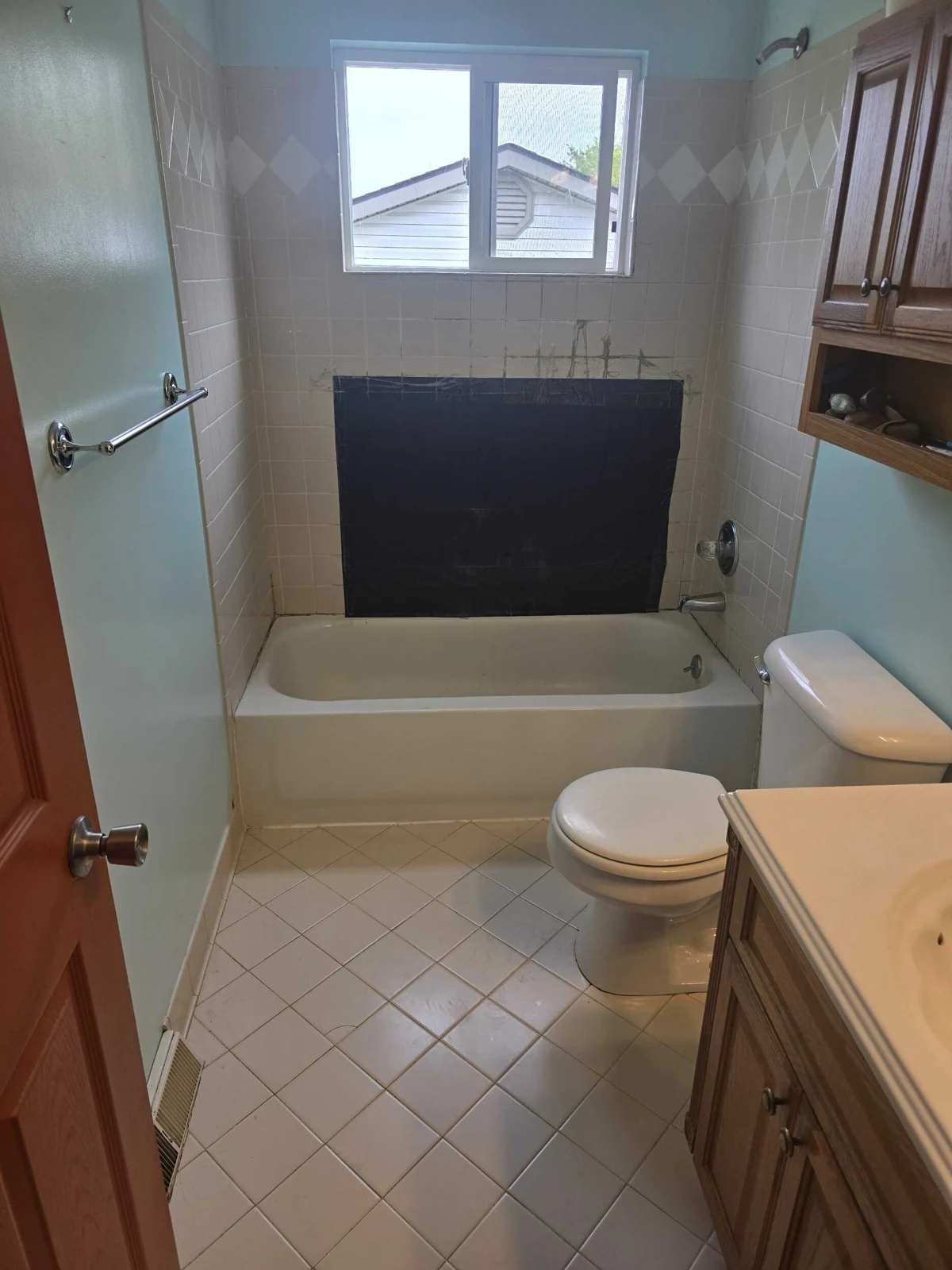 Picture of shower wall with window in shower and water damage