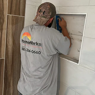 HomeWorks carpenter installing corner wall cabinet