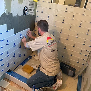 HomeWorks carpenter installing corner wall cabinet