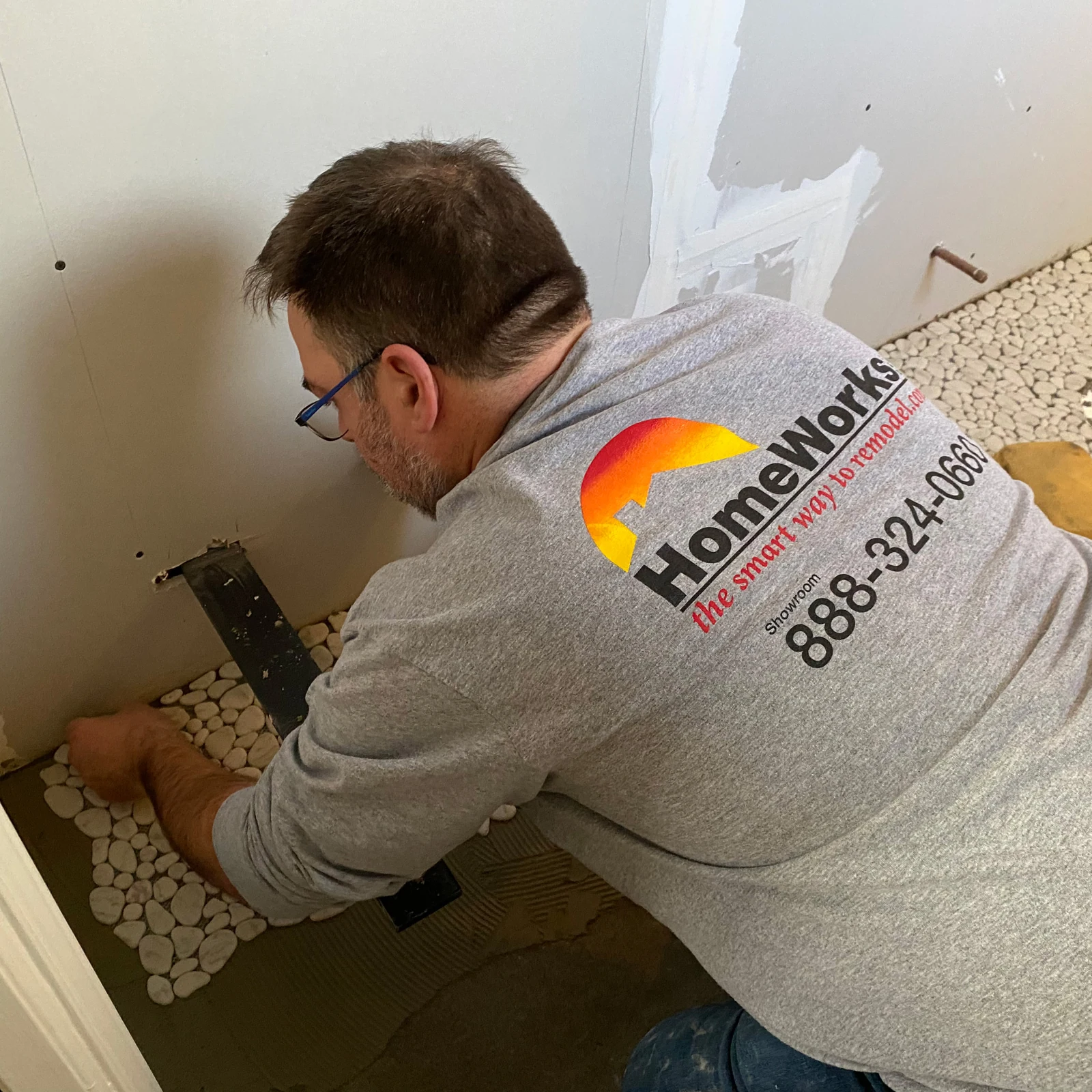 HomeWorks cgo carpenter checking level of kitchen base cabinets