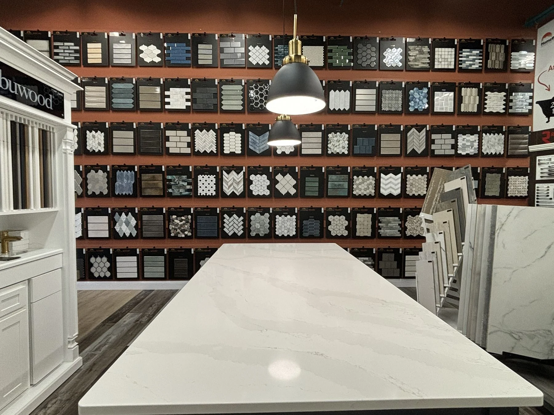Design table in front of the tile wall at the HomeWorks showroom