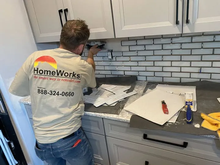 HomeWorks employee installing a kitchen backsplash