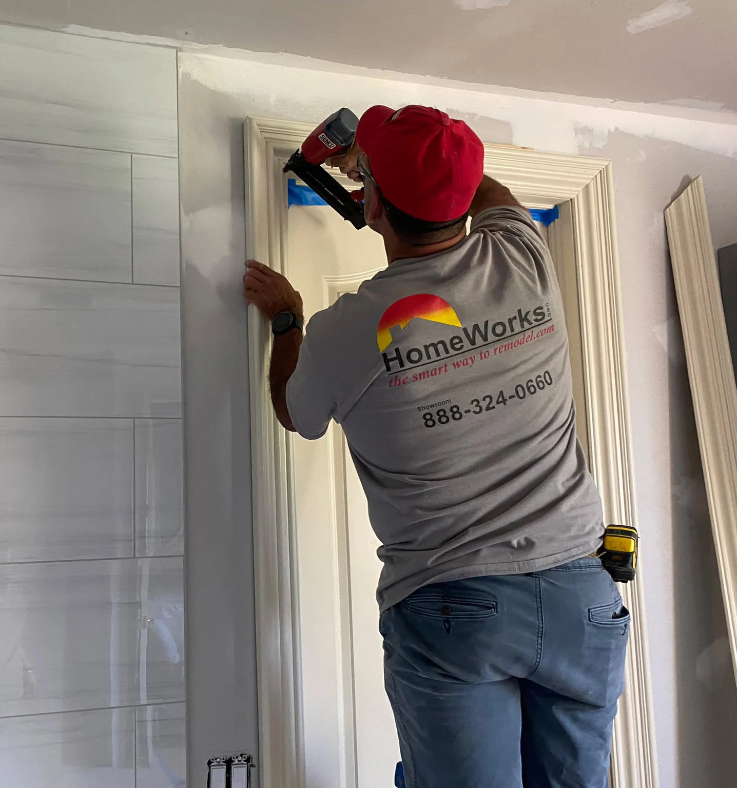 HomeWorks employee installing a kitchen backsplash